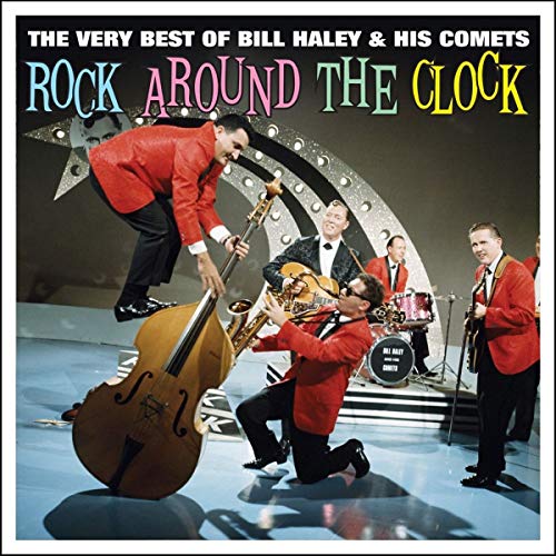 Bill Haley and His Comets performing on stage with instruments in front of stars.