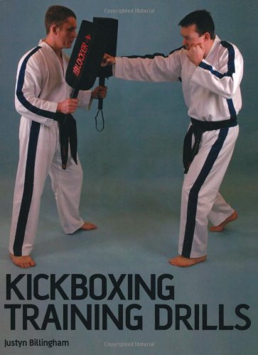Two martial artists in white uniforms practicing a punch against a handheld target pad.