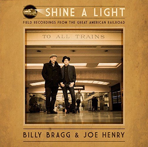 Album cover with two men standing in a train station, sepia-toned image.