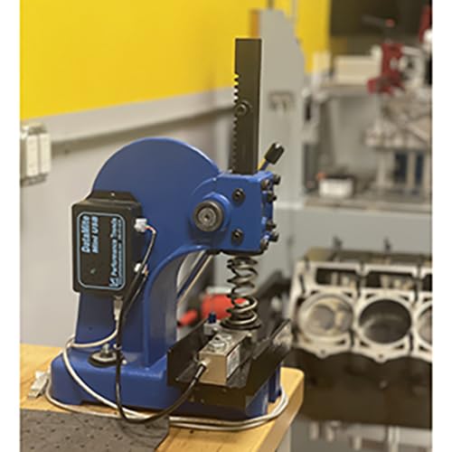Blue cam testing machine with a coiled spring and metal components.