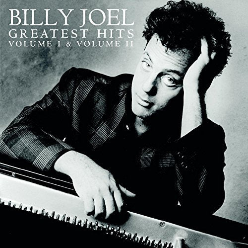 Black and white album cover featuring Billy Joel leaning on a piano.