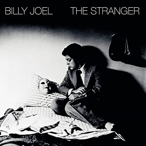 Billy Joel's "The Stranger" album cover: a man and mask in a room.