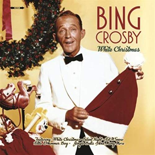 Bing Crosby in a white suit holding a Santa hat, Christmas album cover.