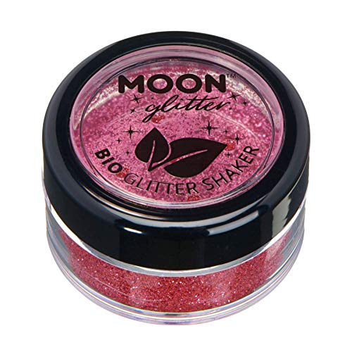 A small round container filled with pink cosmetic glitter by Moon Glitter.