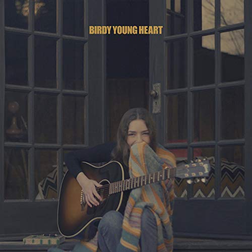 Birdy album cover: woman with guitar, wrapped in a colorful blanket.