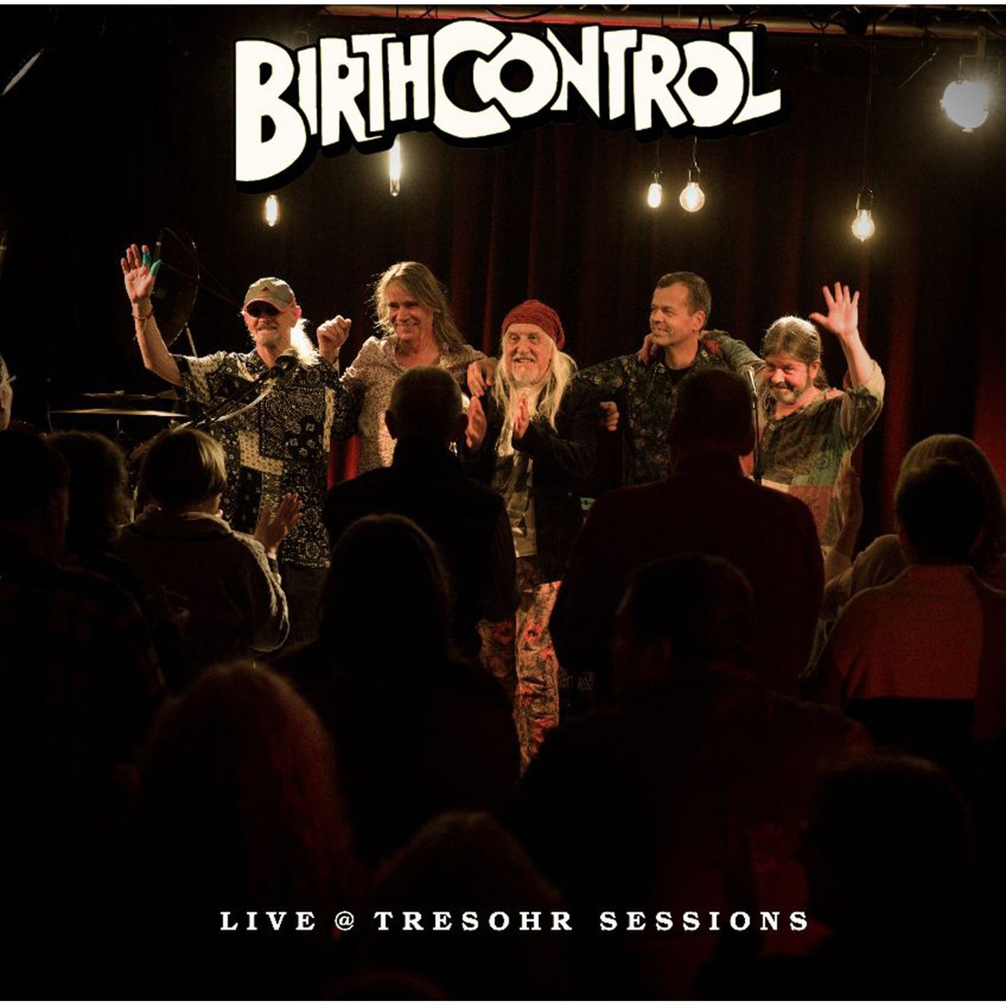 Band Birth Control performing live on stage with an audience.