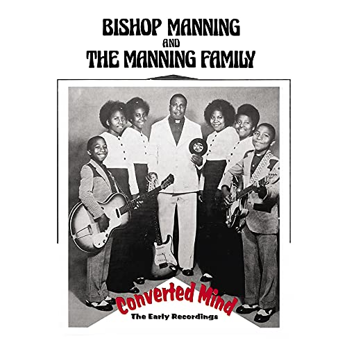 Black and white photo of Bishop Manning and The Manning Family with guitars.