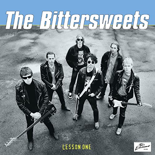 Black and white photo of a five-person rock band, album cover.