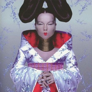 Bjork wearing a kimono, tall hair, and a neck ring against a textured background.