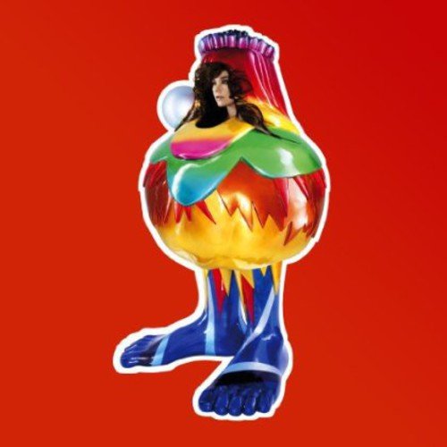 Björk's face on a colorful, abstract, anthropomorphic figure against a red background.