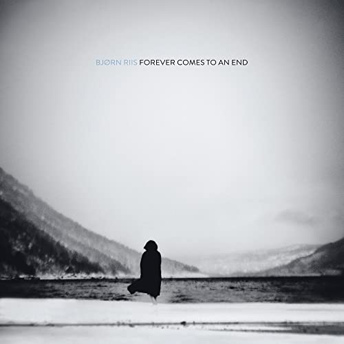Black and white album cover featuring a lone figure by water.