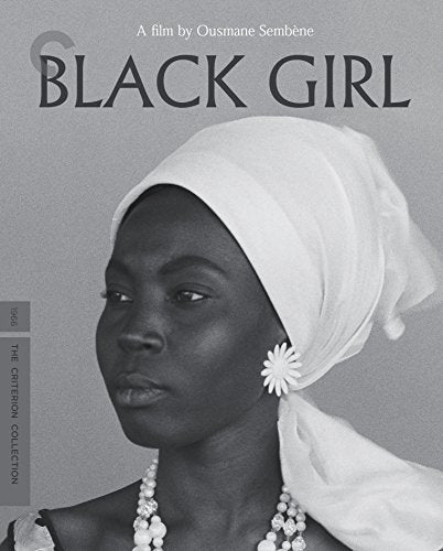 Black and white portrait of a woman wearing a headscarf and daisy-shaped earring.