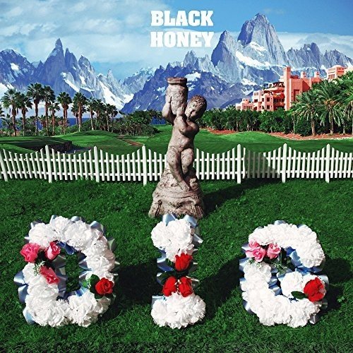 A vinyl record cover featuring a statue and floral wreaths with "Black Honey" text.