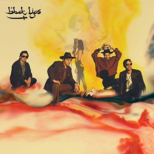 Black Lips album cover: four figures against a blurred, colorful background.
