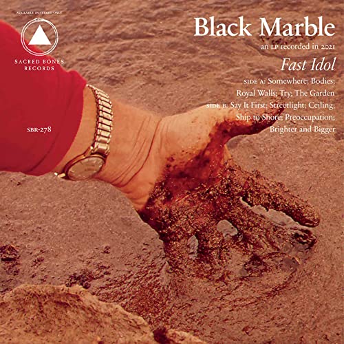 Vinyl record cover: hand emerging from sand, red and brown tones.