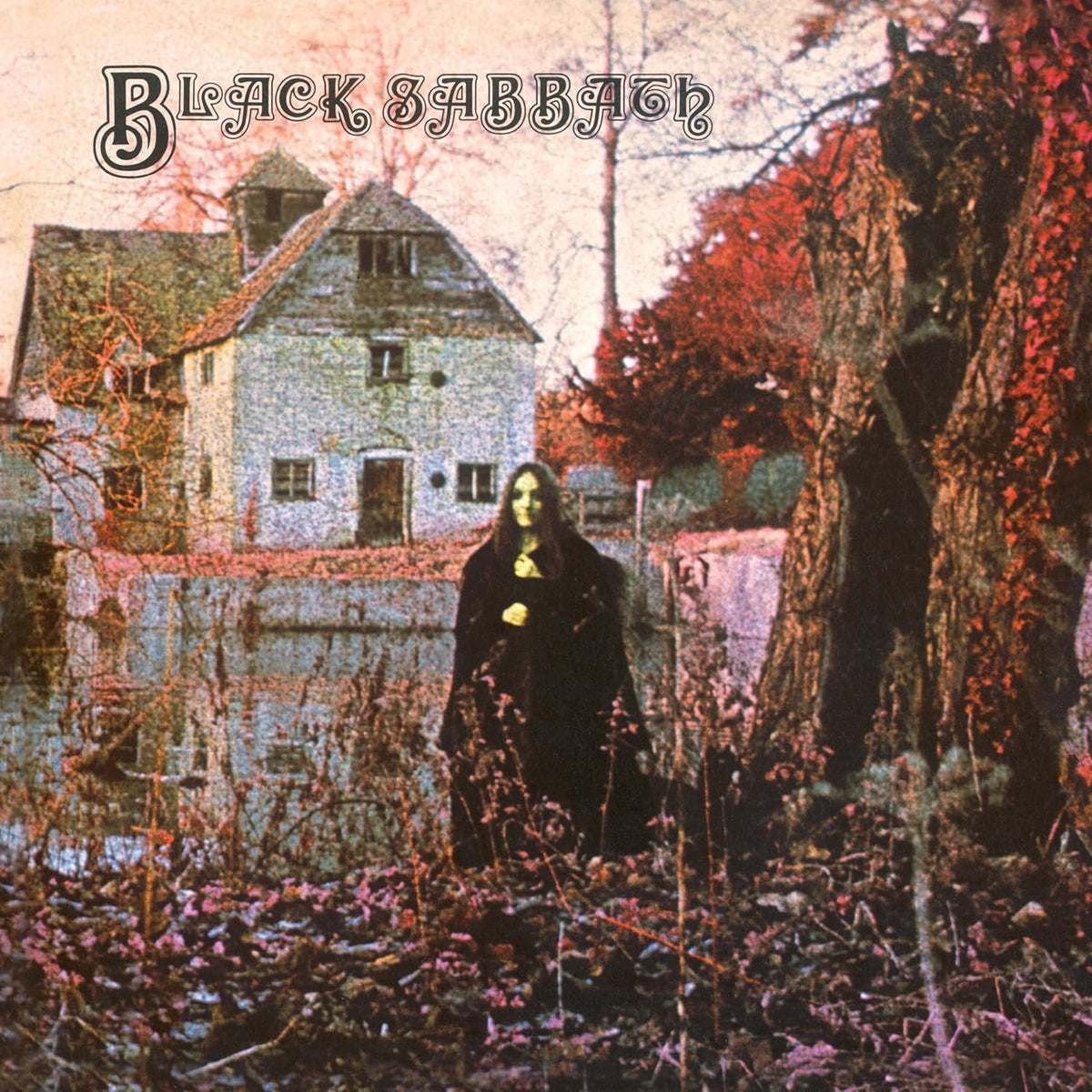 Black Sabbath album cover: a cloaked figure before a house and tree.