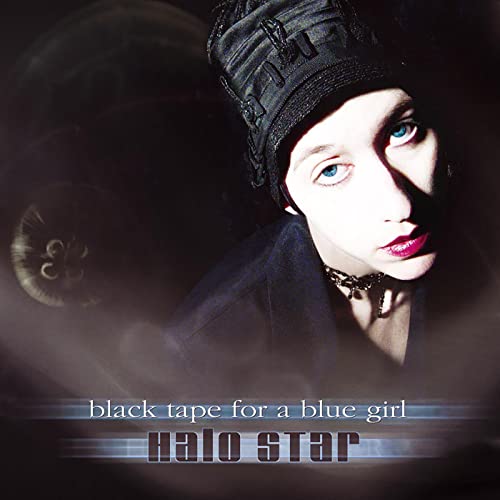 CD cover featuring a person in a black hat and choker against dark background.