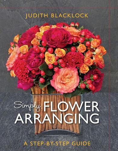 Book cover with a lush, colorful flower arrangement in a glass container.