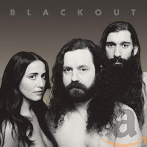 Black and white portrait of three people with long hair.