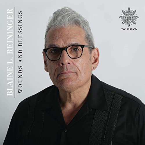 Portrait of Blaine L. Reininger, a man with gray hair and glasses.