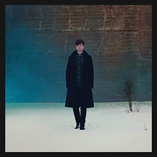 James Blake album cover: man in black coat stands in snow.