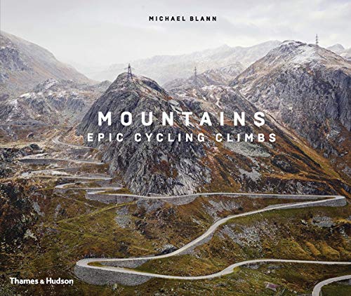 Book cover showing a winding mountain road with rocky peaks under a cloudy sky.