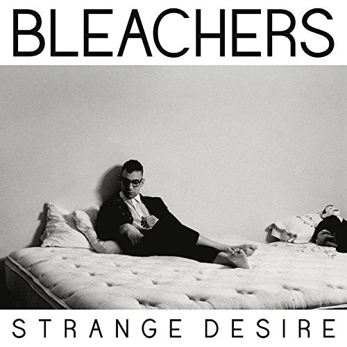 Black and white album cover for Bleachers’ “Strange Desire” featuring a man on a bed.