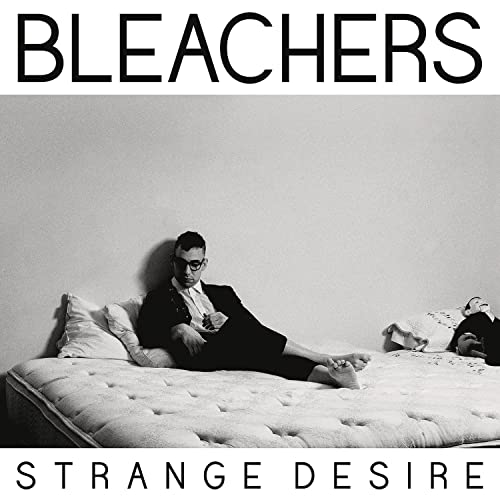 Black and white album cover for Bleachers’ “Strange Desire” with a man lounging on a bed.