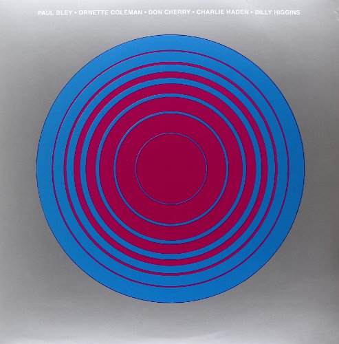 Vinyl cover featuring concentric blue and magenta circles on a grey background.