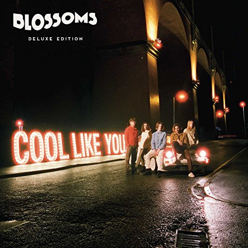 Blossoms album cover featuring a band under illuminated lettering and arches.