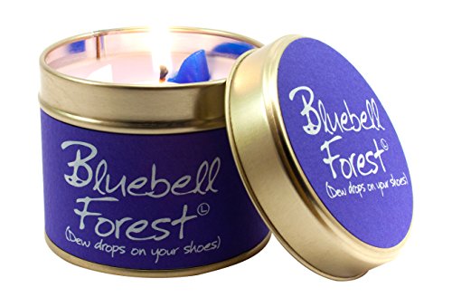 Lit Bluebell Forest scented candle in a gold tin with a purple label.