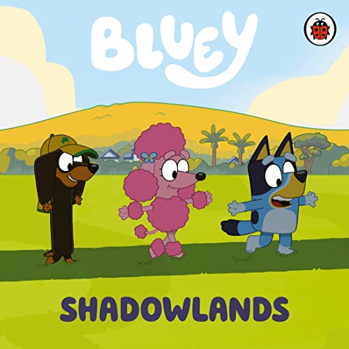 Bluey, Bingo, and a pink poodle dog stand in a green field.