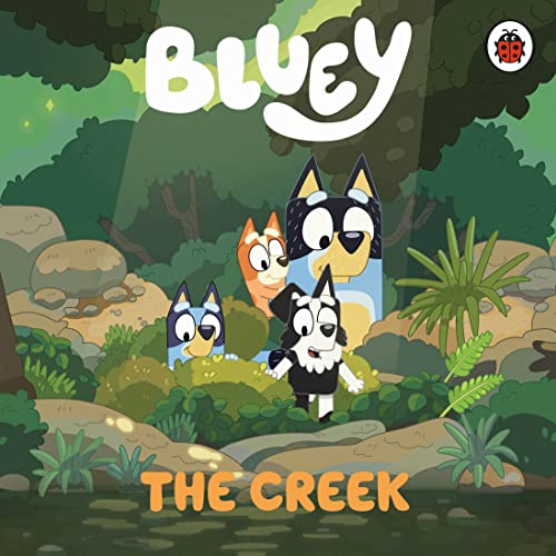 Bluey, Bingo, and Mackenzie standing in a lush, rocky creek setting.