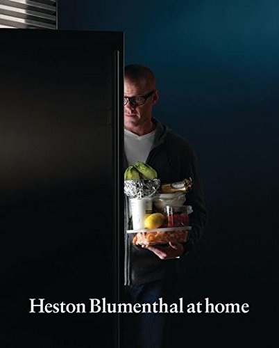 Heston Blumenthal holding a tray of food near an open refrigerator.