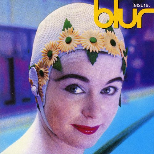 A woman wearing a white swim cap decorated with yellow daisies against a pool background.