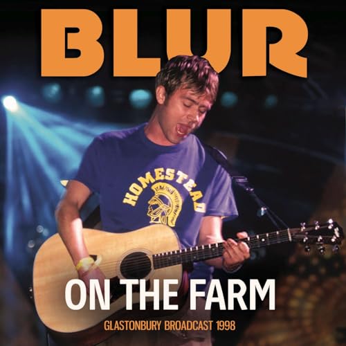 Blur album cover featuring Damon Albarn playing acoustic guitar onstage.