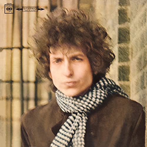 Bob Dylan with curly hair wearing a checkered scarf on the Blonde on Blonde cover.
