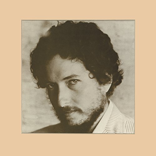 Sepia-toned portrait of Bob Dylan with curly hair and a beard.