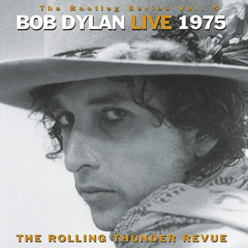 Black and white close-up of Bob Dylan wearing a hat with text overlay.