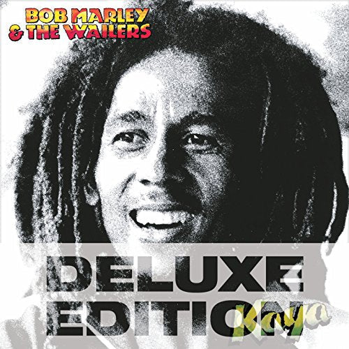Black and white photo of Bob Marley with dreadlocks and a subtle smile.