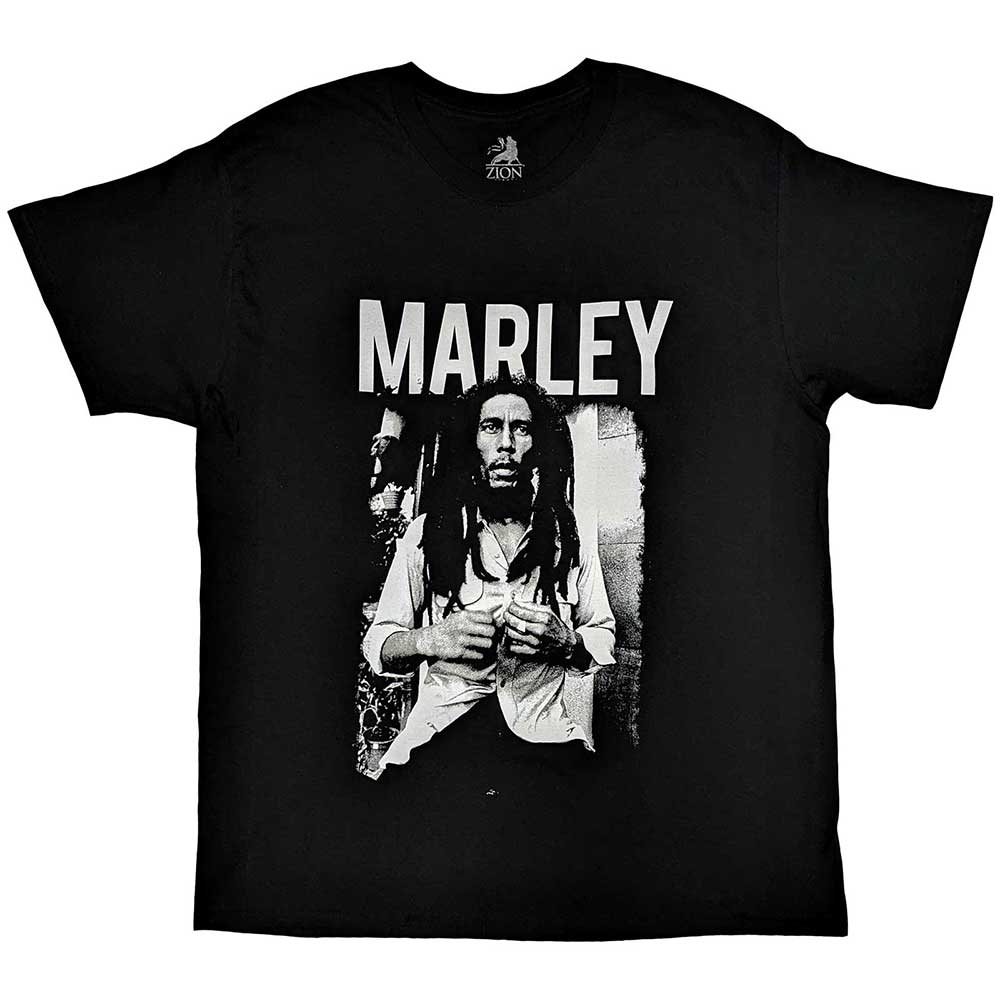 A man wearing a black t-shirt featuring a black and white Bob Marley portrait.
