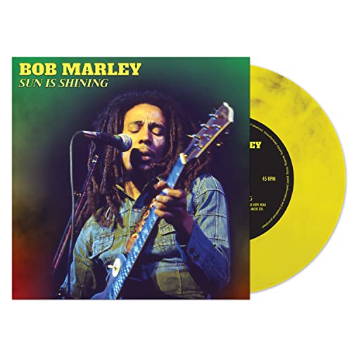 Bob Marley album cover and yellow vinyl record, side view.