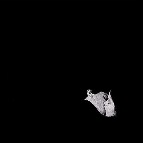 Black and white album cover with two figures embracing in darkness.