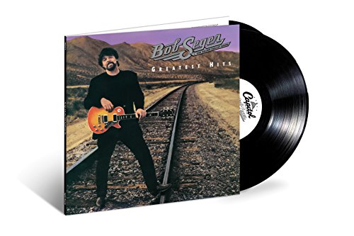 Bob Seger standing on train tracks holding a guitar on a vinyl record cover.
