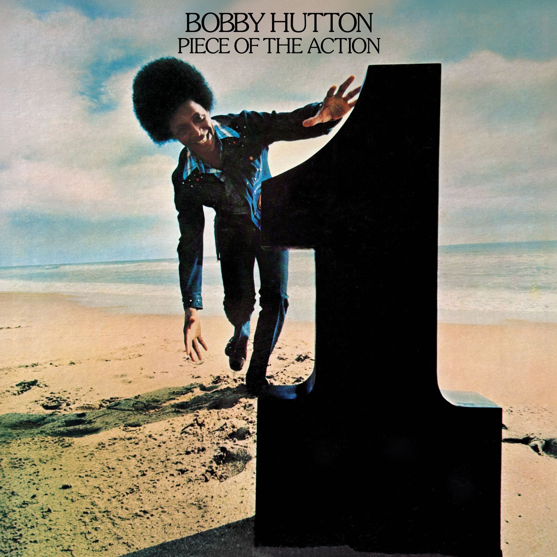 Album cover: Bobby Hutton leaning on a large number one by the sea.