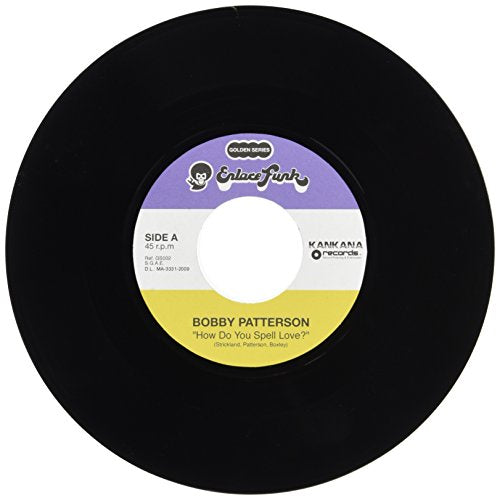 A black 7-inch vinyl record with a label featuring purple, white, and yellow sections.