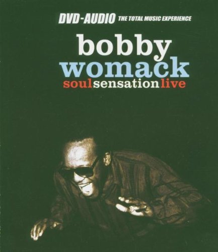 "Bobby Womack crouches, holding a microphone, on a dark green album cover."