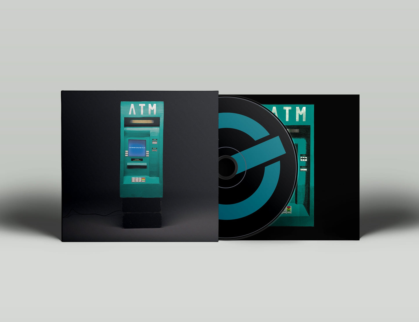 CD cover and disc featuring a teal ATM on a black background.