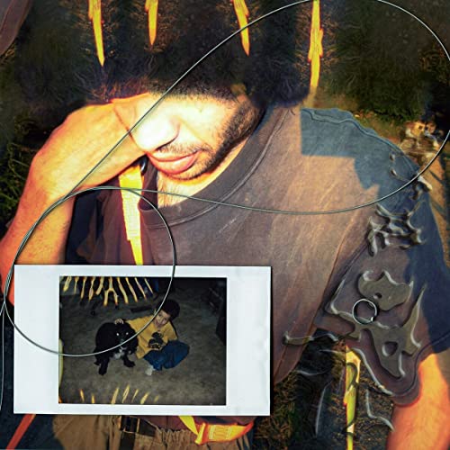 Album cover featuring a man with beard and a small inset photo.