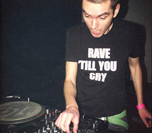 Man DJing with "RAVE TILL YOU CRY" t-shirt, operating a soundboard with a vinyl record nearby.